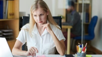 Frowning businesswoman looking at her laptop.